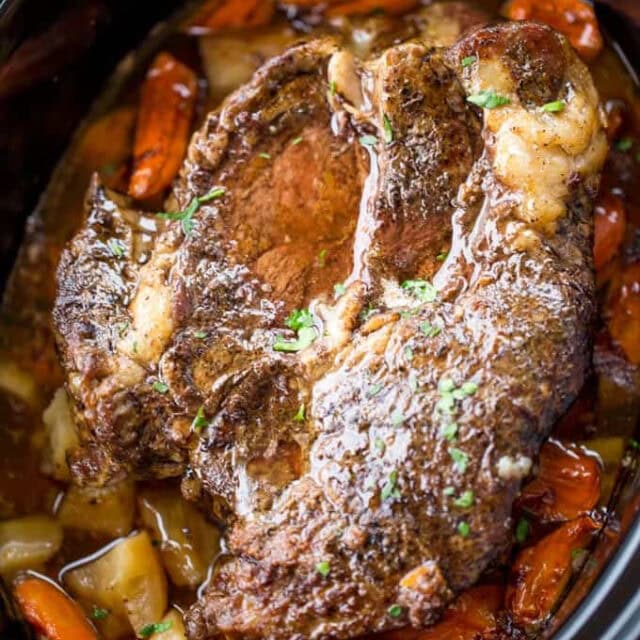 Ultimate Slow Cooker Pot Roast cooked roast in crockpot with potatoes and carrots.