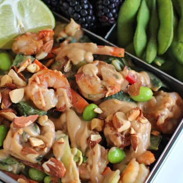 Salad with peanut sesame dressing, shrimp, and almonds with berries