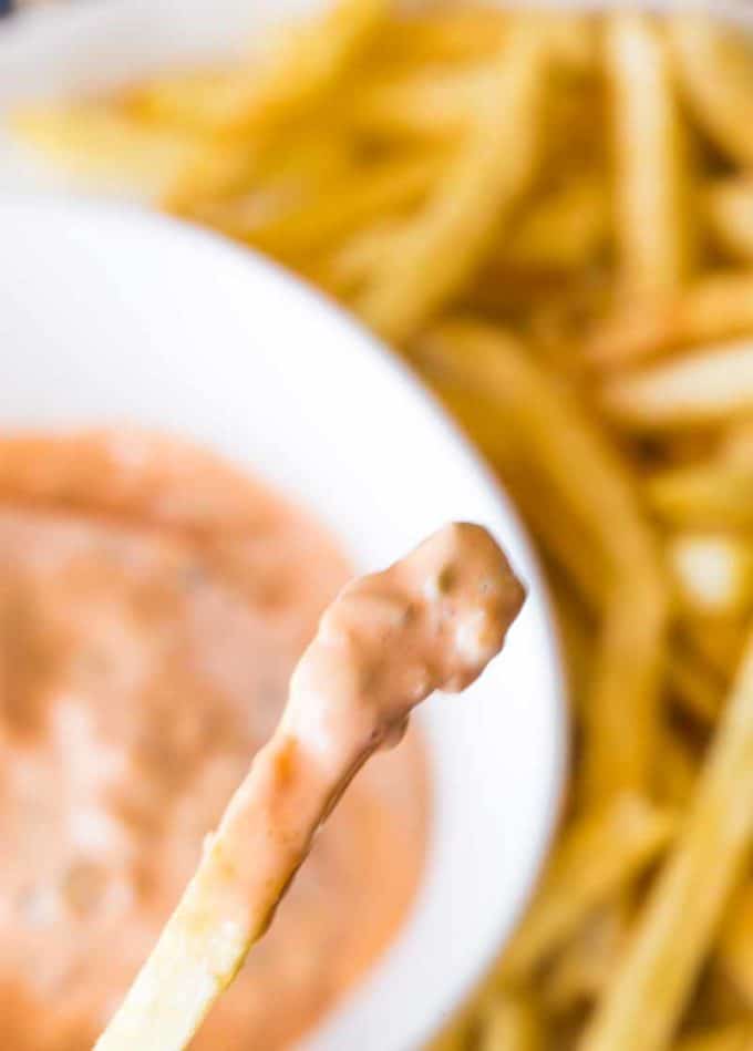 In-N-Out Sauce on a fry close up with fries and sauce in background