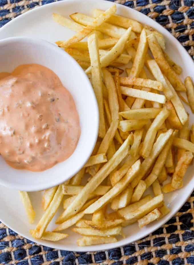 In-N-Out Burger Spread combined in bowl next to fries on plate