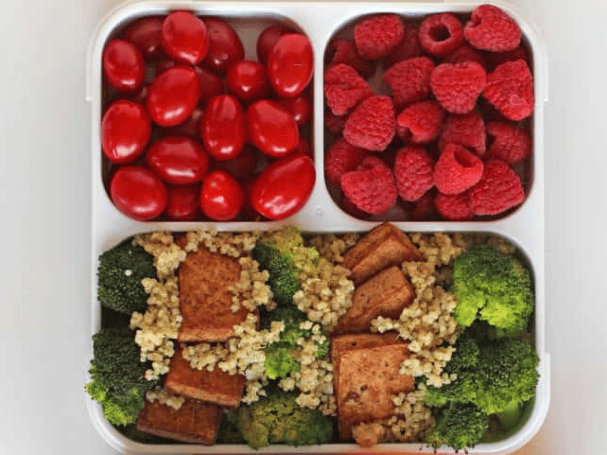 three section dish with tofu dinner, tomatoes, and raspberries