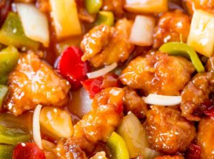 Sweet and Sour Chicken with crispy chicken, pineapple and bell peppers that tastes just like your favorite takeout place without the food coloring.