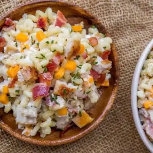 Pasta salad served in wooden bowl