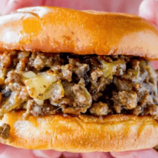 meat mixture inside buns with hand holding