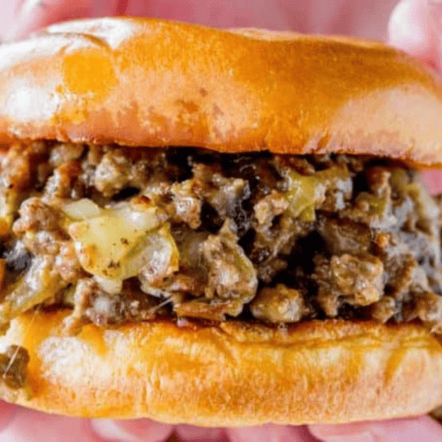 meat mixture inside buns with hand holding