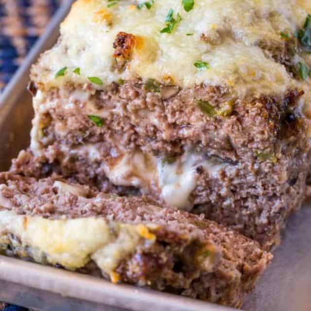 Philly Cheesesteak Meatloaf with green bell bell peppers, onions and mushrooms topped and stuffed with Provolone Cheese.