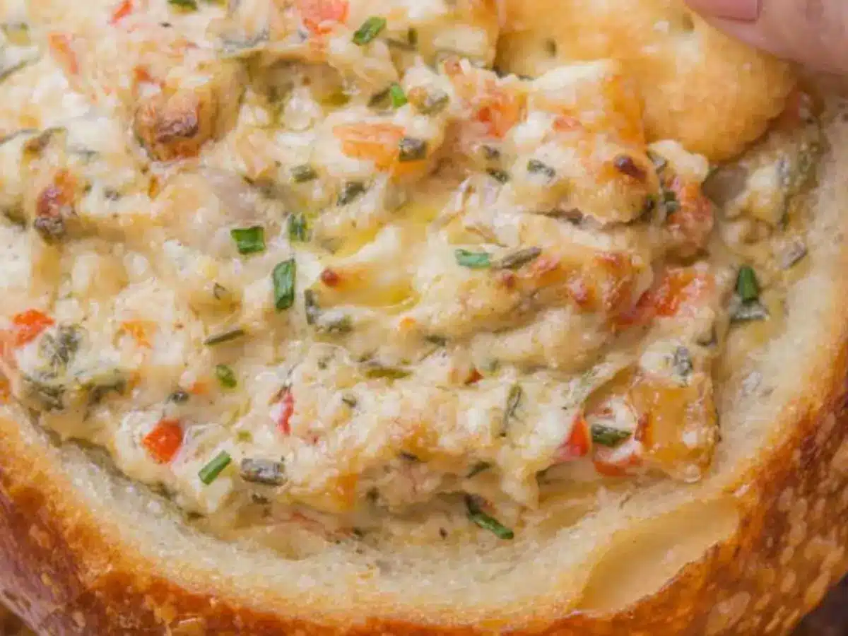 Close up of cooked creamy spicy dip in bread bowl