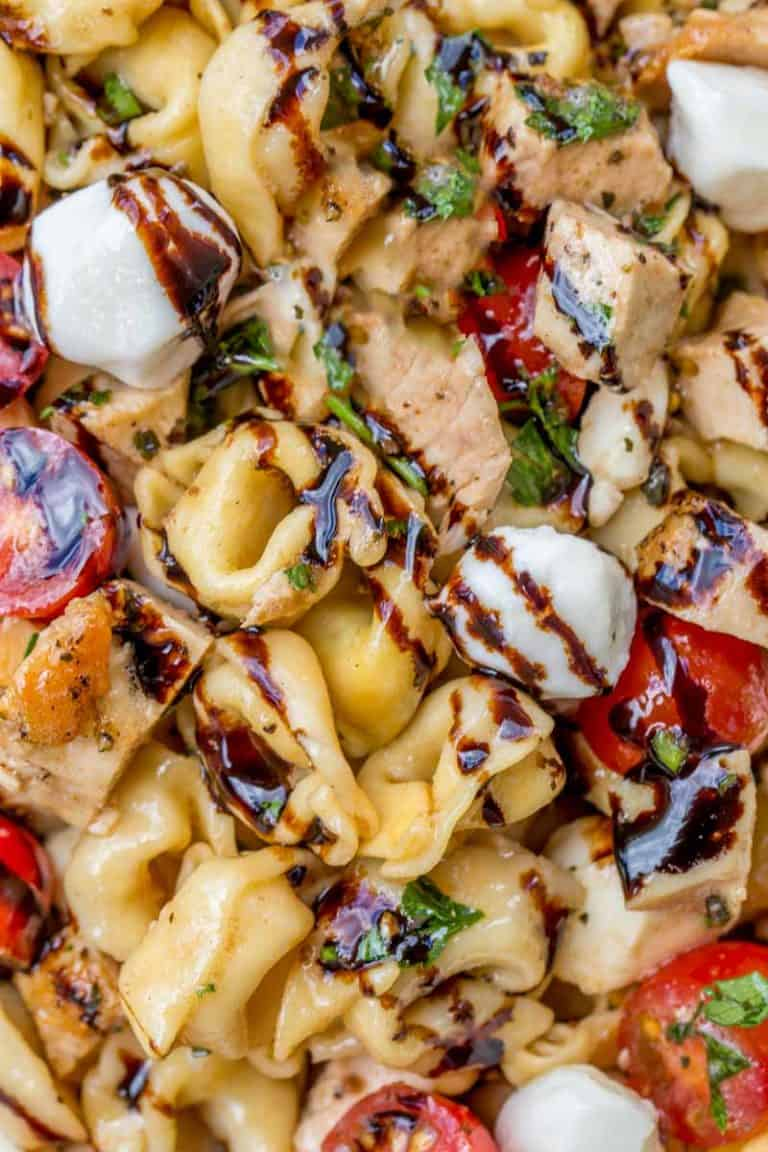 Close up photo of tortellini pasta salad with balsamic glaze