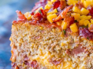 Bacon Cheeseburger Meatloaf topped and stuffed with cheddar cheese and bacon is the ultimate meatloaf. Makes amazing sandwiches too.