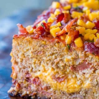Bacon Cheeseburger Meatloaf topped and stuffed with cheddar cheese and bacon is the ultimate meatloaf. Makes amazing sandwiches too.