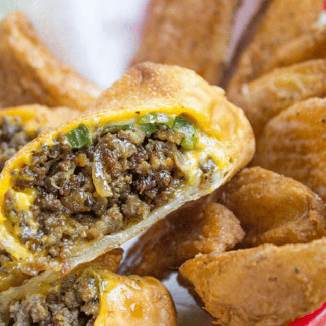 Halved egg rolls with potato wedges