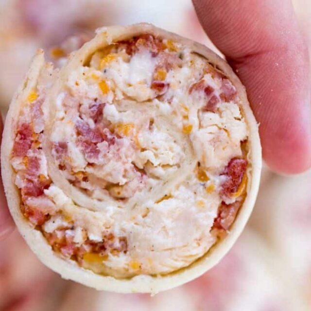 hand holding tortilla wrapped food