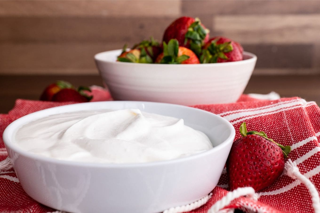 Homemade Cool Whip in bowl with strawberries served
