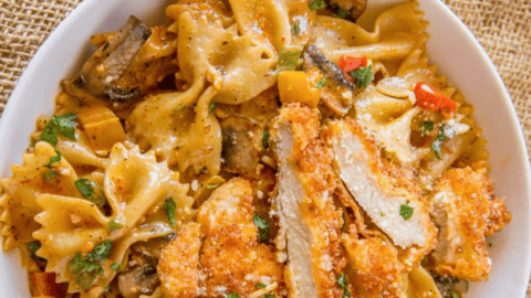 bowl of pasta topped with breaded chicken