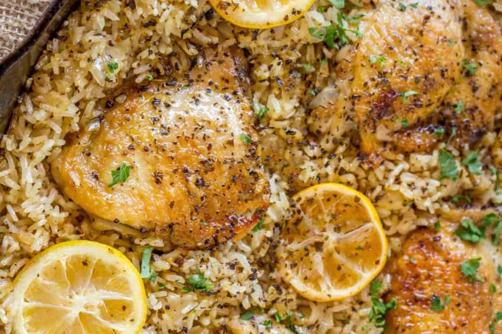 pot of cooked chicken on rice with lemon slices