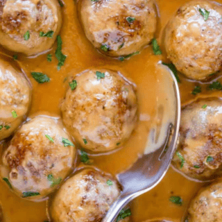 Meatballs being scooped with spoon