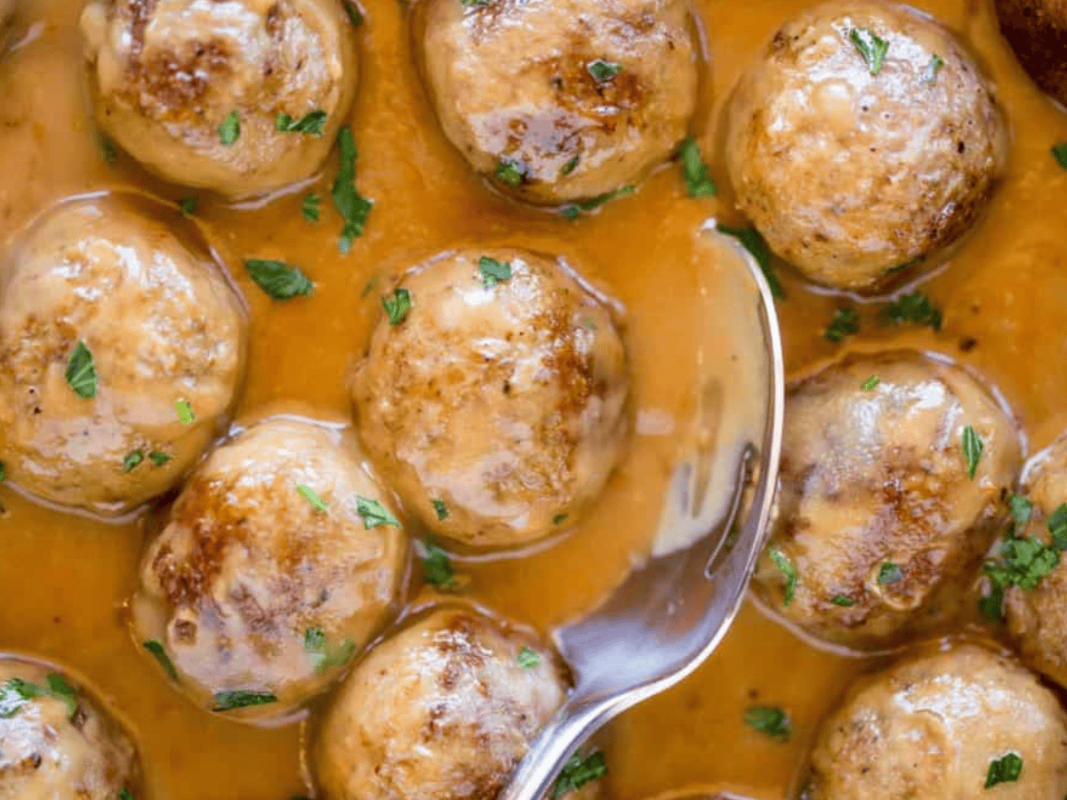 Meatballs being scooped with spoon