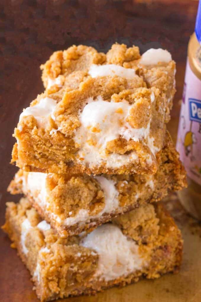 Pumpkin Fluffernutter Bars are the perfect mix of peanut butter brownie, marshmallow filling and all things pumpkin and fall flavored. Best back to school snack ever.