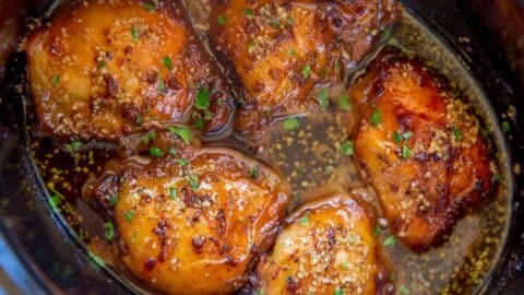 Seasoned Chicken thighs cooked in slow cooker pot.