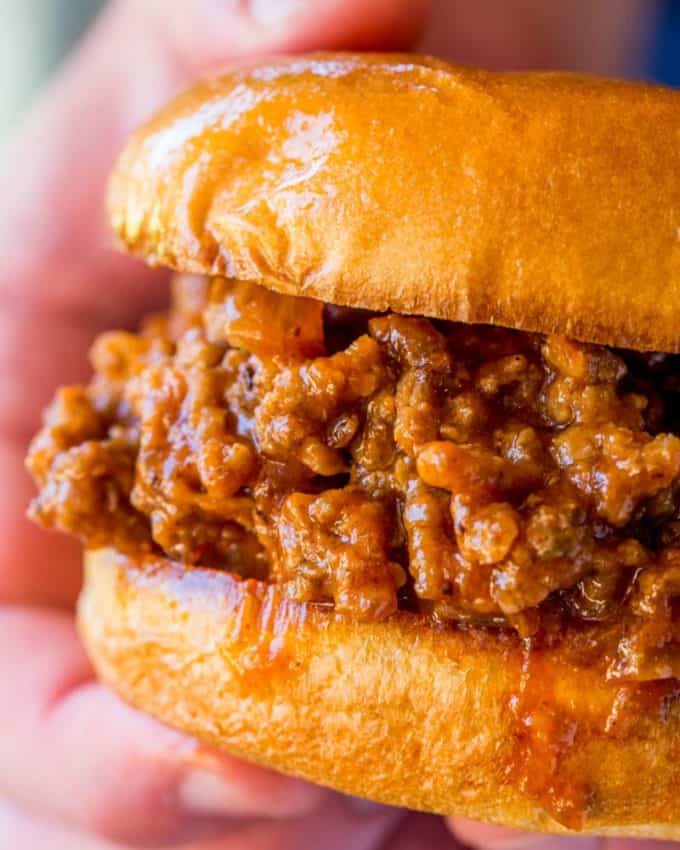 A sloppy joe is a sandwich consisting of ground beef or pork, onions ...