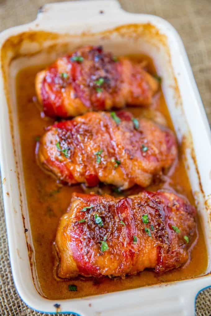 white baking dish with chicken wrapped in bacon