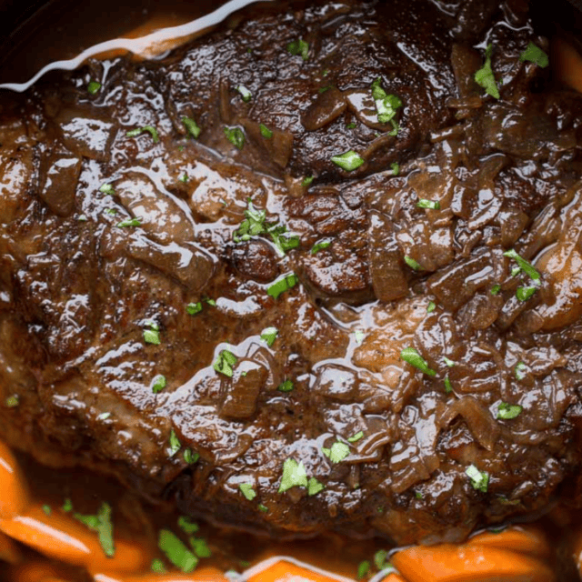 Cooked pot roast with carrots in slow cooker