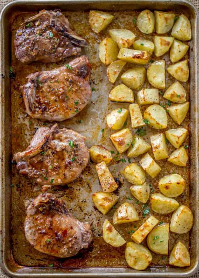 Oven Baked Pork Chops in brown sugar and garlic on a sheet pan with yukon potatoes. One pan, easy cleanup and the family will love them. Easy Oven Baked Pork Chops made on a sheet pan in just 5 minutes of prep time!