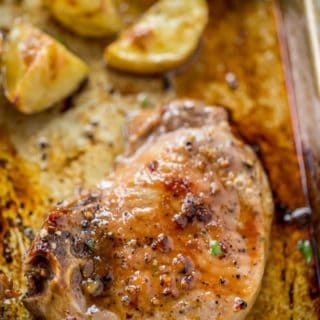 Oven Baked Pork Chops covered in brown sugar and garlic made on a sheet pan with yukon potatoes. One pan, almost no cleanup and the whole family will love them.