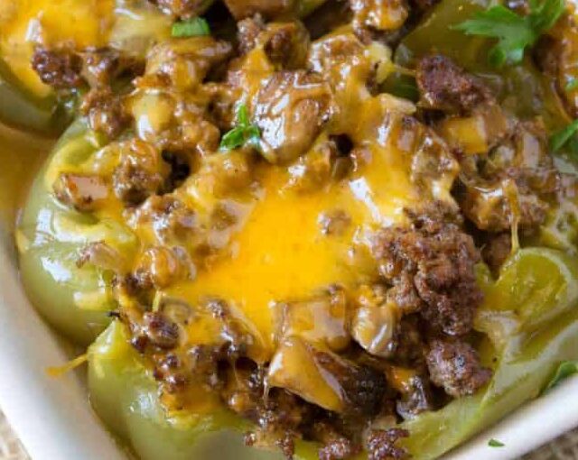 Philly Stuffed Peppers in a pan with cheese on top.