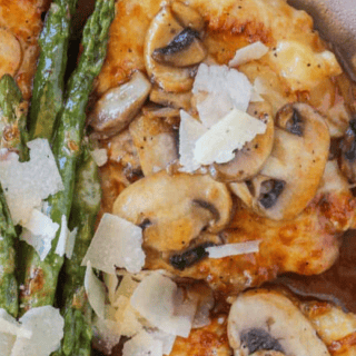 Close up of chicken served with asparagus