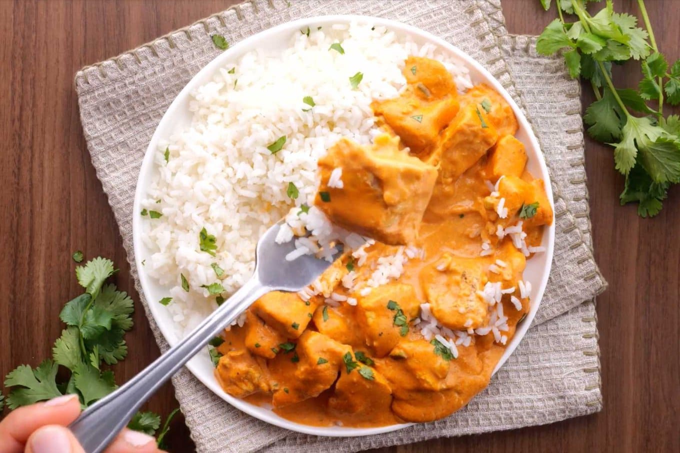 Slow Cooker Indian Butter Chicken on plate with rice and fork