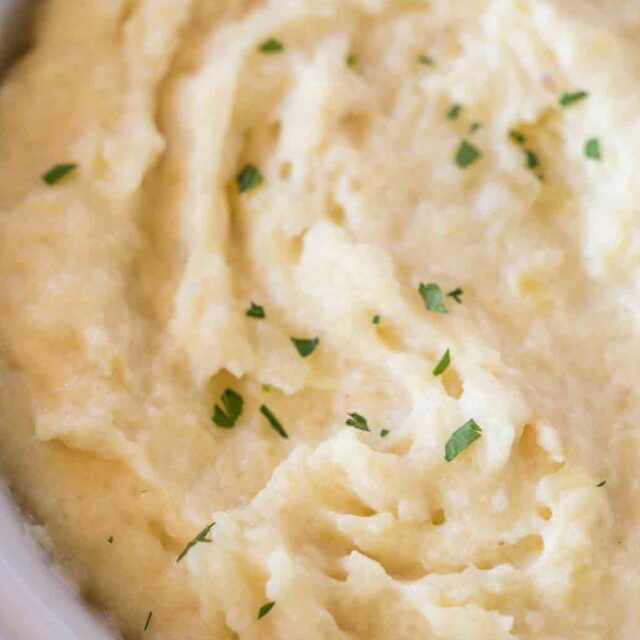 soft and fluffy mound of spud with green garnish in a bowl