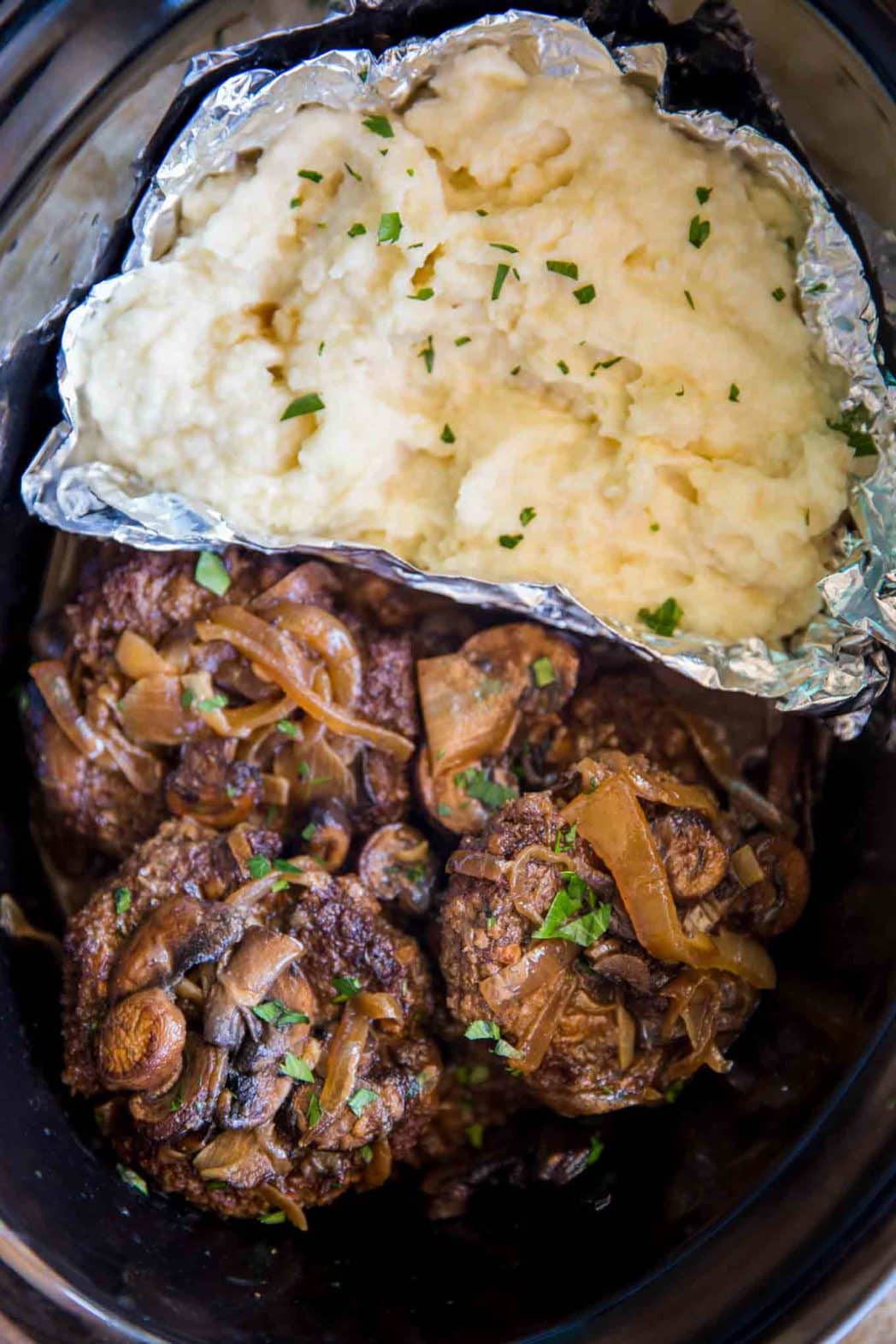 Slow Cooker Salisbury Steak and Mashed Potatoes in a SINGLE slow cooker with mashed potatoes, rich gravy, mushrooms and onions over tender beef patties.