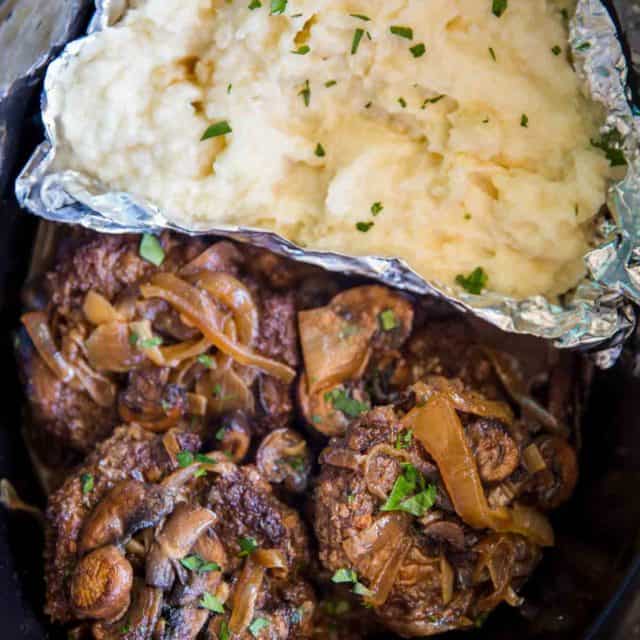 Slow Cooker Salisbury Steak and Mashed Potatoes in a SINGLE slow cooker with mashed potatoes, rich gravy, mushrooms and onions over tender beef patties.