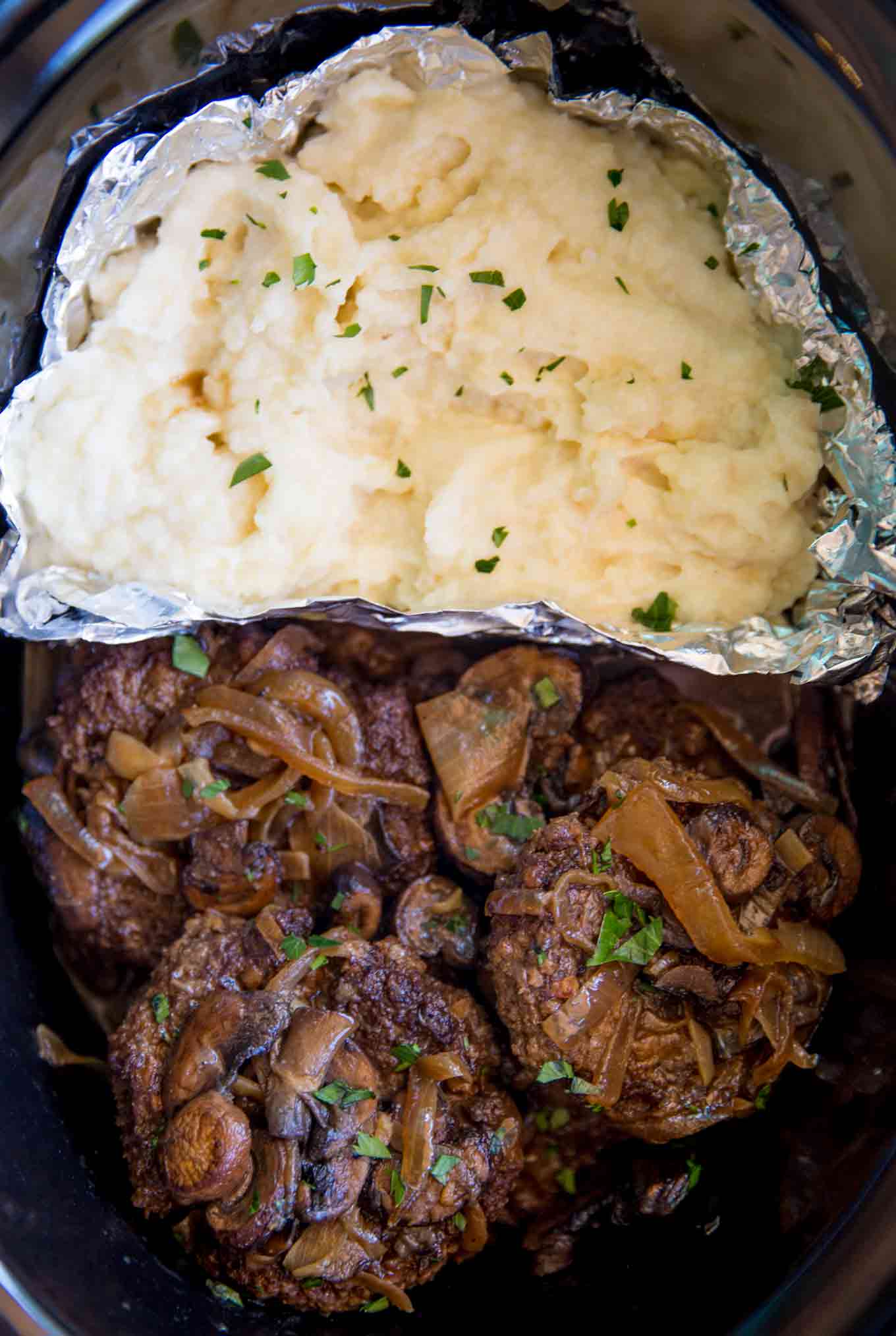 An entire meal in your slow cooker. Slow Cooker Salisbury Steak and Mashed Potatoes is an easy hearty meal!