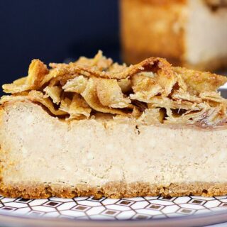 Slice of cheesecake on blue patterned plate.