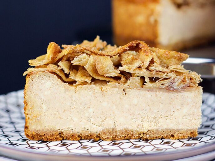 Slice of cheesecake on blue patterned plate.
