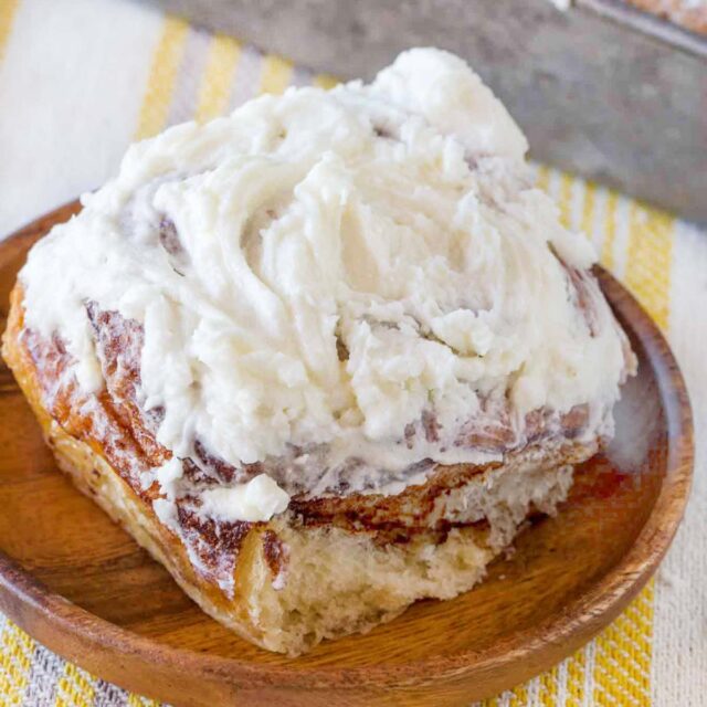 Easy Cinnamon Roll with cream cheese icing on wooden plate