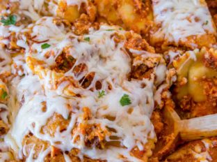 Easy Ravioli Lasagna Bake with three cheeses and ground beef is an easy weeknight meal you can prep ahead that tastes like lasagna with half the effort!