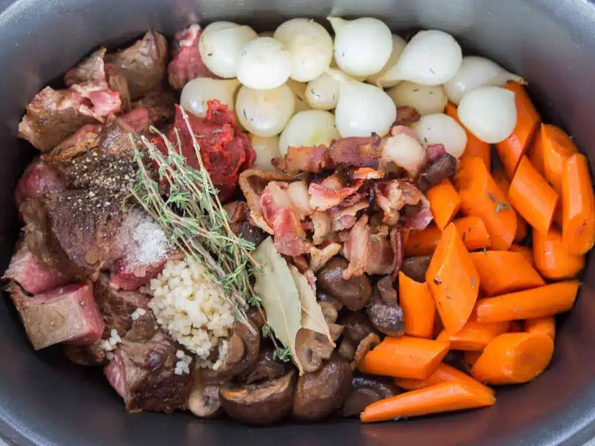 Top view of uncooked ingredients for soup in a crock pot