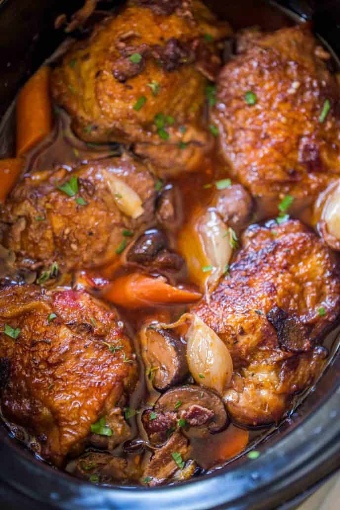 Slow Cooker Coq Au Vin has all the red wine braised chicken flavors with shallots, chicken, garlic, mushrooms and carrots in the classic French dish you love.