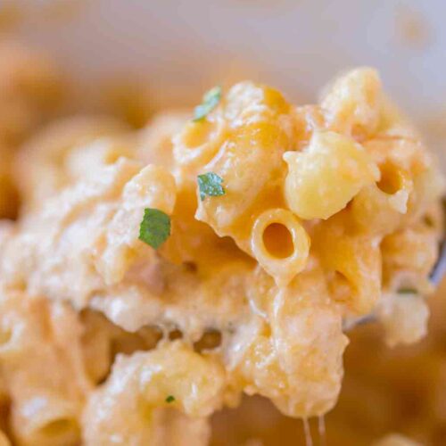 slow cooker of Macaroni and Cheese with spoon