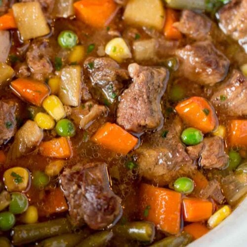 bowl of Slow cooker soup with beef, carrots, and potatoes.