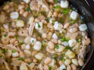 Slow Cooker White Chicken Chili with hominy, white beans, chicken and peppers is the perfect, easy white chicken chili of your dreams.