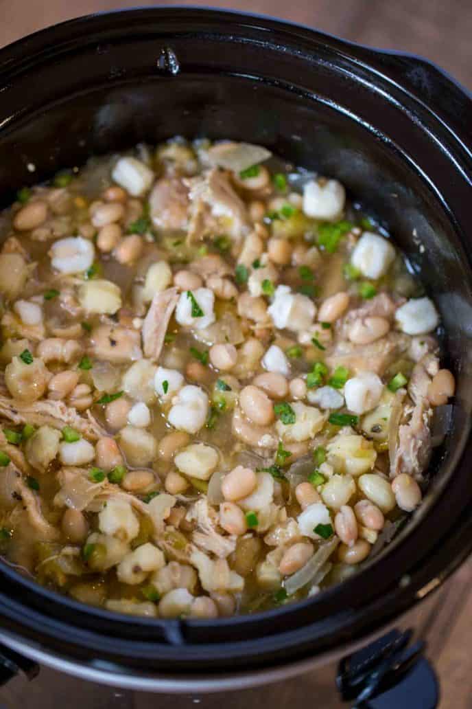 Slow Cooker White Chicken Chili with hominy, white beans, chicken and peppers is the perfect, easy white chicken chili of your dreams.