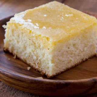 A piece of homemade cornbread on a brown plate