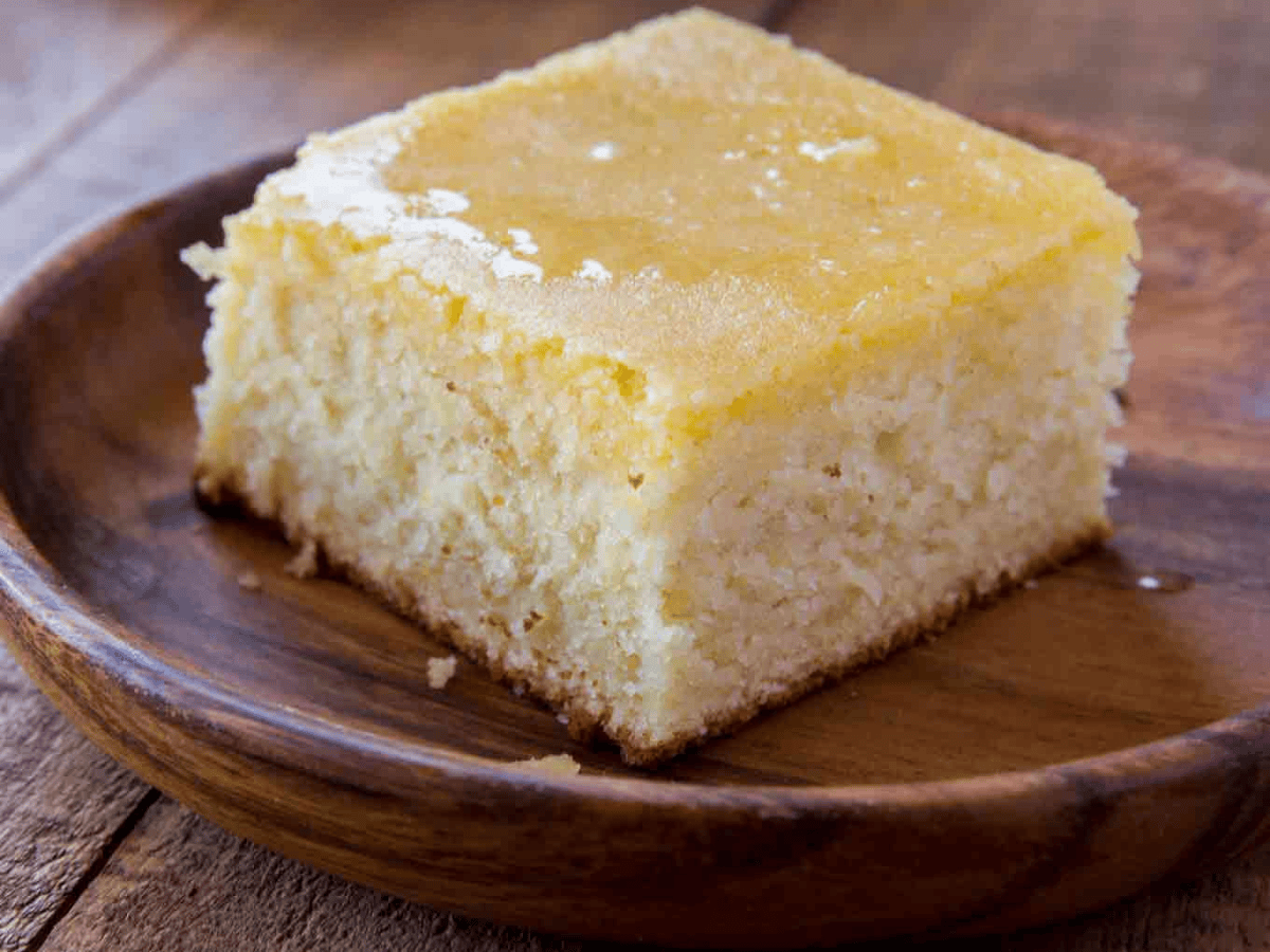 A piece of homemade cornbread on a brown plate