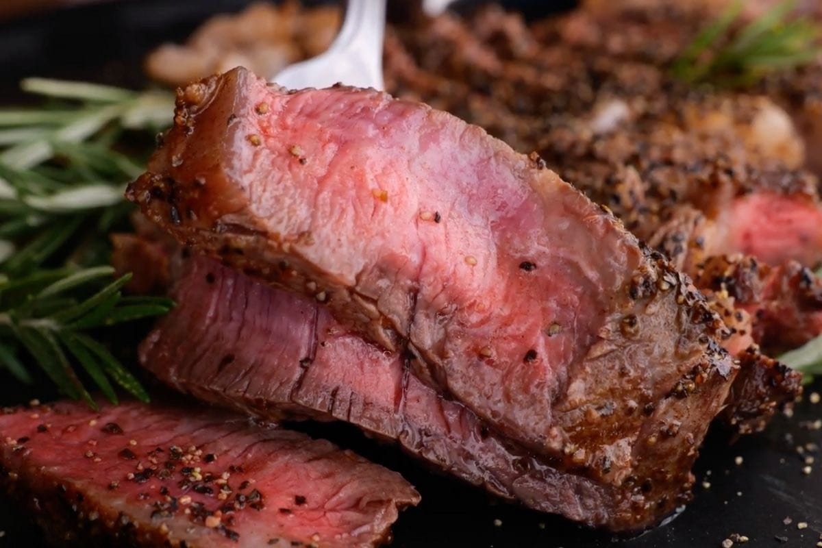 Ribeye Steak sliced on serving platter close up