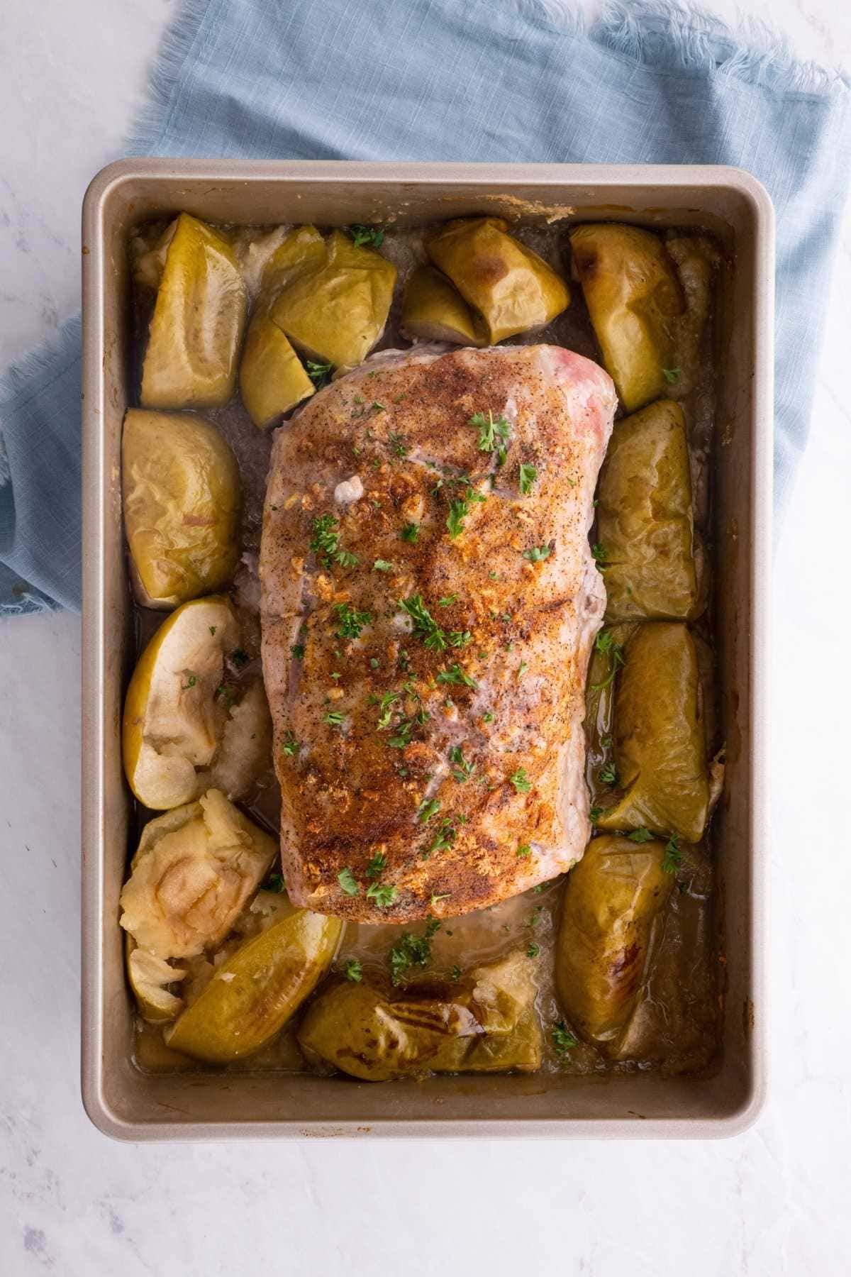 Ultimate Garlic Pork Loin Roast with apples in baking dish