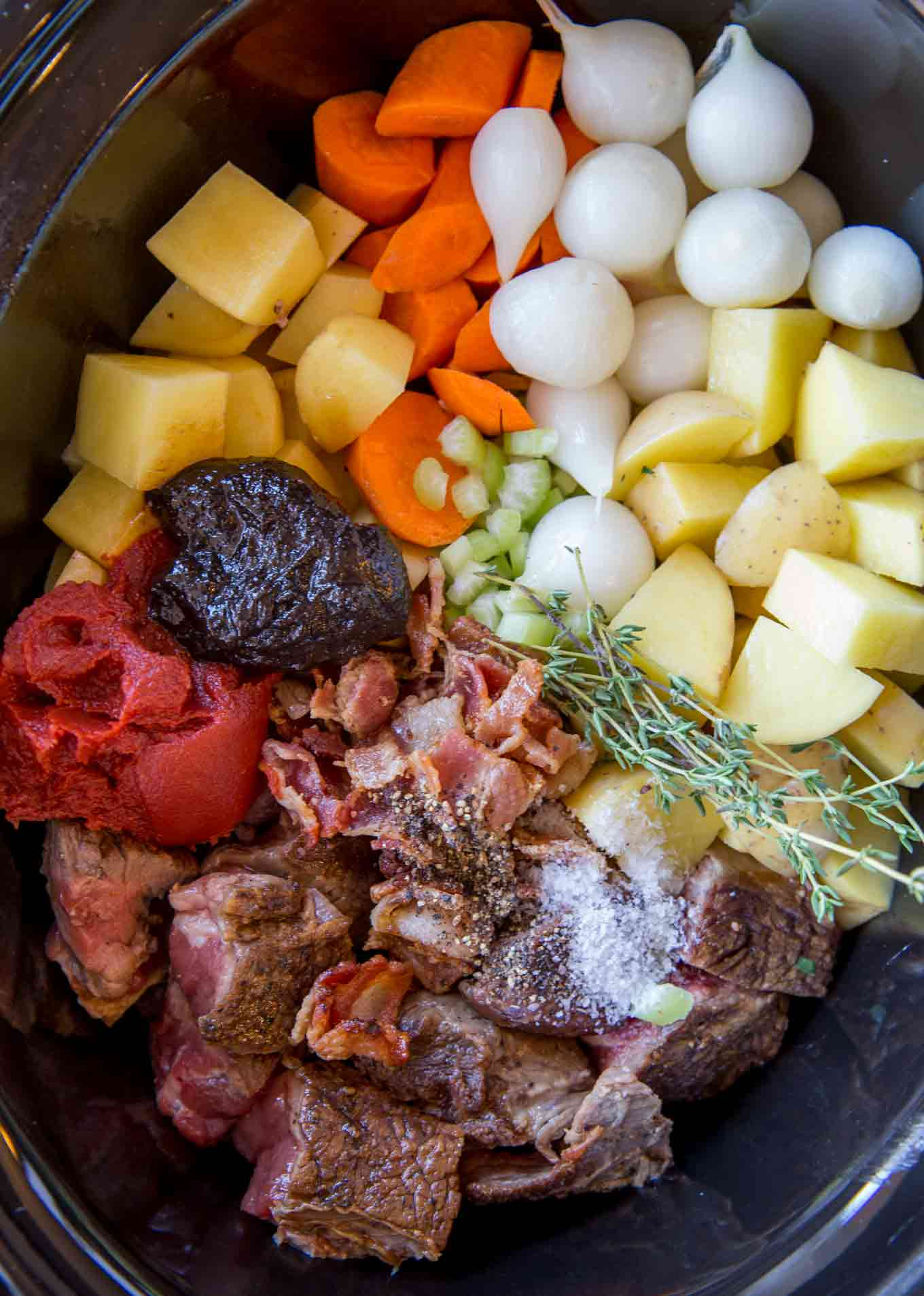 Raw stew ingredients in a slow cooker